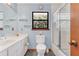 Bright bathroom featuring a dual sink vanity, shower with glass door, and a neutral color scheme at 9222 Charles E Limpus Rd, Orlando, FL 32836