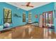 Tranquil bedroom with hardwood floors, ceiling fan, and windows offering serene views at 9222 Charles E Limpus Rd, Orlando, FL 32836