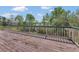 View of the lake from this outdoor deck, enclosed with a wooden railing for safety at 9222 Charles E Limpus Rd, Orlando, FL 32836