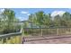 Exterior view of an elevated deck, overlooking the lake and surrounded by lush greenery at 9222 Charles E Limpus Rd, Orlando, FL 32836