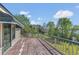 Exterior view of a wooden deck, partially covered, overlooking the property and lake at 9222 Charles E Limpus Rd, Orlando, FL 32836