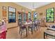Inviting dining room filled with natural light, wood floors, and a large table at 9222 Charles E Limpus Rd, Orlando, FL 32836