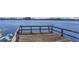 Wooden dock extending over calm blue waters, perfect for lakeside relaxation and recreation at 9222 Charles E Limpus Rd, Orlando, FL 32836