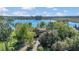 Charming lakefront property enveloped by mature trees, offering a tranquil retreat and picturesque views, tucked away in nature at 9222 Charles E Limpus Rd, Orlando, FL 32836