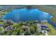 Secluded lakefront property features mature trees, private dock, and serene vistas from its naturally lush surroundings at 9222 Charles E Limpus Rd, Orlando, FL 32836
