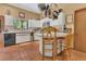 Bright kitchen with white cabinets, terracotta tile floor, and stainless steel appliances at 9222 Charles E Limpus Rd, Orlando, FL 32836