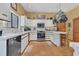 Bright kitchen with white cabinets, terracotta tile floor, and stainless steel appliances at 9222 Charles E Limpus Rd, Orlando, FL 32836