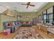 Spacious living room featuring a large sectional sofa, area rug, and hardwood floors at 9222 Charles E Limpus Rd, Orlando, FL 32836
