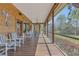 Expansive screened porch perfect for entertaining, with views of the well-kept lawn, plants, and lake at 9222 Charles E Limpus Rd, Orlando, FL 32836