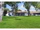 Spacious backyard featuring a well-maintained lawn with mature trees at 10665 Whitman Cir, Orlando, FL 32821
