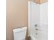 A bathroom featuring a white toilet, shower and bathtub at 10665 Whitman Cir, Orlando, FL 32821