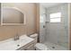 Modern bathroom featuring a vanity and walk-in shower with white marble-style tile at 10665 Whitman Cir, Orlando, FL 32821