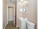 Neat half-bath with framed mirror and white vanity cabinet at 10665 Whitman Cir, Orlando, FL 32821