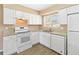 A kitchen featuring white cabinetry, granite countertops, stainless steel appliances, and wood-look flooring at 10665 Whitman Cir, Orlando, FL 32821