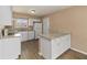 Bright kitchen featuring white cabinetry, granite countertops, stainless steel appliances, and wood-look flooring at 10665 Whitman Cir, Orlando, FL 32821