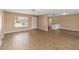 Spacious living room featuring modern wood floors and plenty of natural light from a large window at 10665 Whitman Cir, Orlando, FL 32821