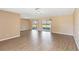 Bright living room showcasing wood floors and sliding glass doors to the outdoor patio area at 10665 Whitman Cir, Orlando, FL 32821