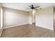 An empty living room featuring wood-look flooring, neutral colored walls, and a ceiling fan at 10665 Whitman Cir, Orlando, FL 32821