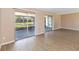 Bright and airy living room with modern flooring and sliding glass doors to an outdoor space at 10665 Whitman Cir, Orlando, FL 32821