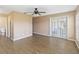 A living room featuring wood-look flooring, neutral colored walls, and French doors to an outdoor space at 10665 Whitman Cir, Orlando, FL 32821