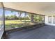 Covered, screened-in patio area overlooks a large backyard with mature trees at 10665 Whitman Cir, Orlando, FL 32821