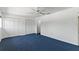Spacious bedroom with plush blue carpet, white walls, a ceiling fan and double closets at 1152 Grove St, Maitland, FL 32751