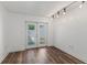 Bright bonus room featuring wood floors, neutral walls and natural light entering through the glass paneled double doors at 1152 Grove St, Maitland, FL 32751