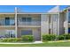 Exterior shot of condo with a screened balcony, muted color scheme, and manicured landscaping at 1152 Grove St, Maitland, FL 32751