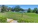 View of the grassy grounds, lake, and neighboring condos, with maintained landscaping at 1152 Grove St, Maitland, FL 32751