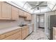 Bright kitchen features white countertops, white appliances and elegant marble-look tile flooring at 1152 Grove St, Maitland, FL 32751