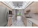 Bright kitchen features a ceiling fan, marbled floors, and stainless steel appliances with an open layout at 1152 Grove St, Maitland, FL 32751