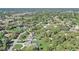 Scenic aerial view of a neighborhood, highlighting lush greenery and residential properties at 1155 Collins Ave, Orange City, FL 32763