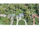 Expansive aerial view of property showcasing well-maintained lawns and a private screened-in pool at 1155 Collins Ave, Orange City, FL 32763