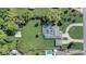 Aerial view showcasing the backyard pool, lush landscaping, and private screened-in pool area at 1155 Collins Ave, Orange City, FL 32763