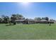 Large backyard showcasing the home's exterior, screened-in porch, and the additional brick outbuilding at 1155 Collins Ave, Orange City, FL 32763