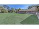 Spacious backyard with lush lawn and mature trees; serene and private with plenty of room for outdoor activities at 1155 Collins Ave, Orange City, FL 32763
