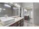 Bright bathroom offering dual vanities, a seamless glass shower, and a view of an adjacent bathroom space at 1155 Collins Ave, Orange City, FL 32763