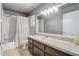 Traditional bathroom with a vanity, standard tub-shower with curtain, and neutral walls and flooring at 1155 Collins Ave, Orange City, FL 32763