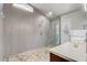 Updated bathroom featuring a modern glass shower, stone floor, and tiled walls for a spa-like experience at 1155 Collins Ave, Orange City, FL 32763