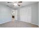 A well-lit bedroom showcases carpet and neutral walls, and a view of an adjacent bathroom at 1155 Collins Ave, Orange City, FL 32763