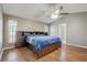 Main bedroom features wood-style floors, vaulted ceiling and large windows at 1155 Collins Ave, Orange City, FL 32763