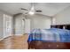 The main bedroom features a vaulted ceiling, a ceiling fan, and wood look floors at 1155 Collins Ave, Orange City, FL 32763