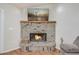 Cozy fireplace features brick surround and wooden mantle at 1155 Collins Ave, Orange City, FL 32763
