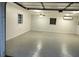 Spacious garage featuring a durable epoxy floor, ample lighting, and mini-split air conditioning at 1155 Collins Ave, Orange City, FL 32763