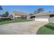Garage exterior with long driveway and well maintained lawn at 1155 Collins Ave, Orange City, FL 32763