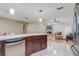 Kitchen featuring stainless steel appliances and view into the living room with a fireplace at 1155 Collins Ave, Orange City, FL 32763