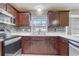 Kitchen boasts modern stainless appliances, stone backsplash and a large window above sink at 1155 Collins Ave, Orange City, FL 32763