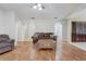 Spacious living room features wood floors, ceiling fan and neutral color palette at 1155 Collins Ave, Orange City, FL 32763