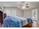 A spacious main bedroom with a ceiling fan, vaulted ceiling, and private exterior door to the pool area at 1155 Collins Ave, Orange City, FL 32763