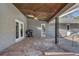 Large brick patio featuring a grill, ceiling fan, brick columns, and access to the screen enclosed pool area at 1155 Collins Ave, Orange City, FL 32763